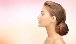 Beautiful Young Woman's profile with pink background