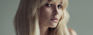 Blonde model showing off perfect rhinoplasty in a nicely lit photo