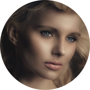 A circular image of a blue eyed woman at a side view shows off her Restylane- L injections for a more contoured face